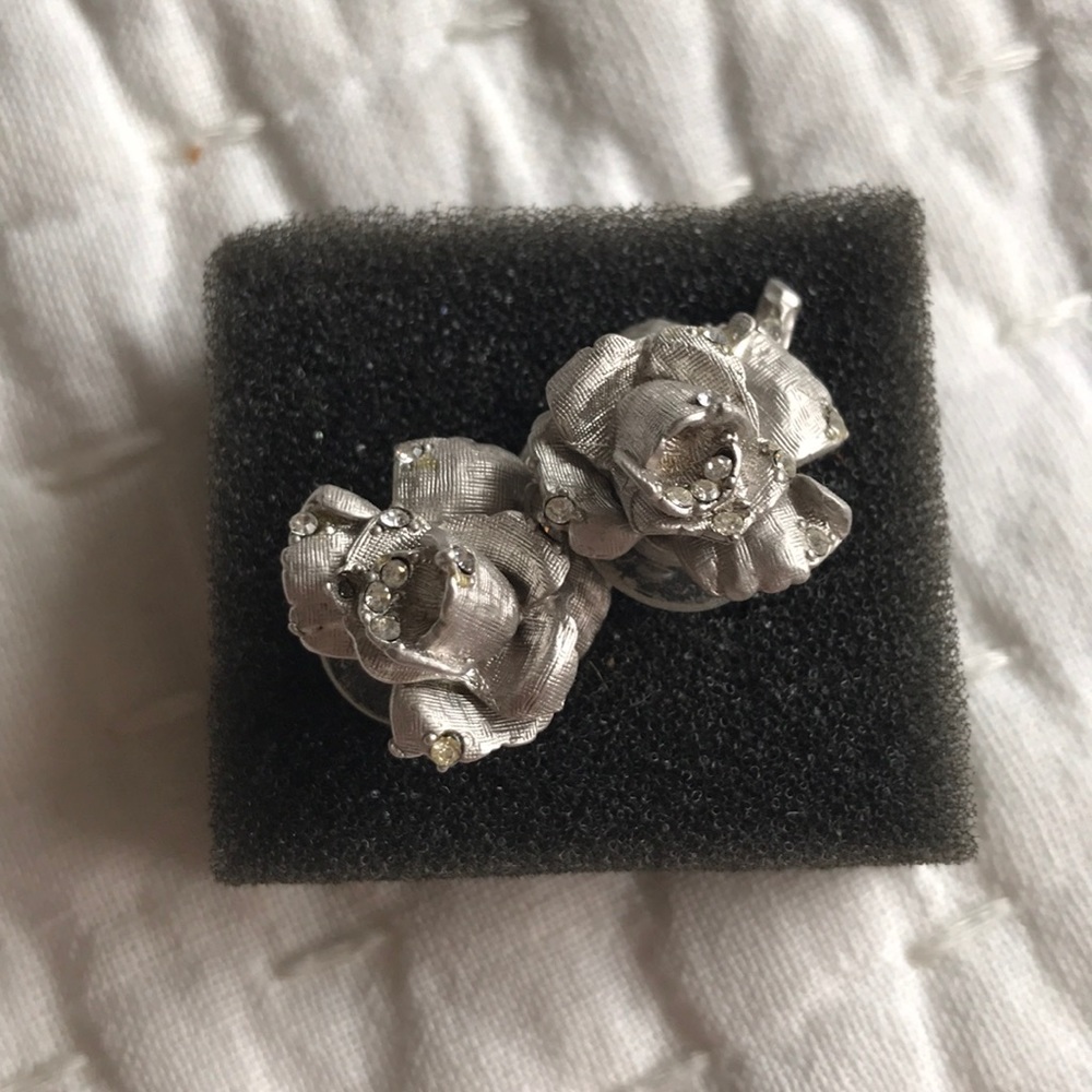 Silver rosebud earrings with stones.